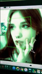 a woman is holding a laptop and a picture of a cat