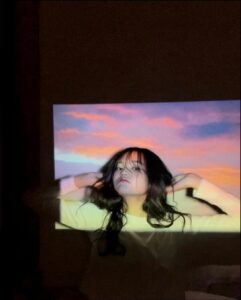 a woman is playing a video game on a tv