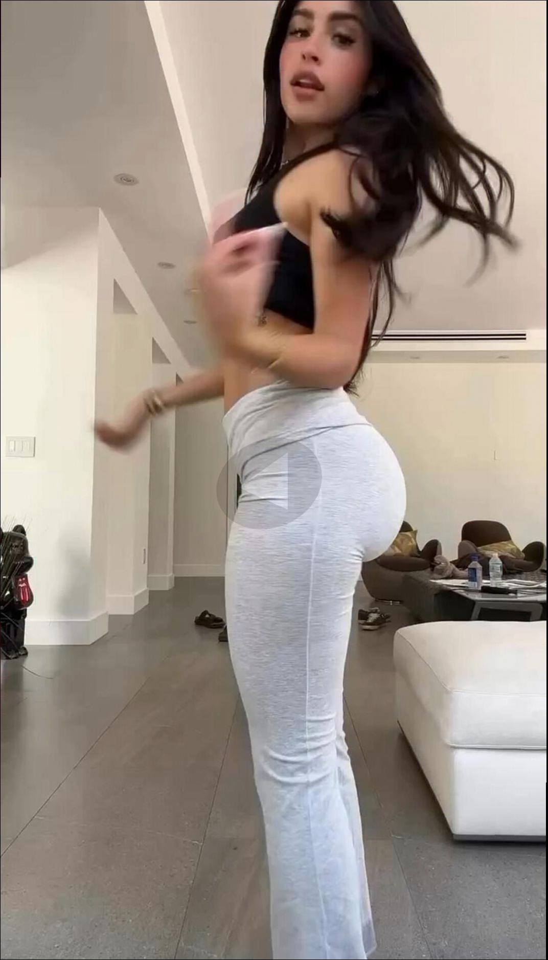 a woman is standing on a floor with a remote