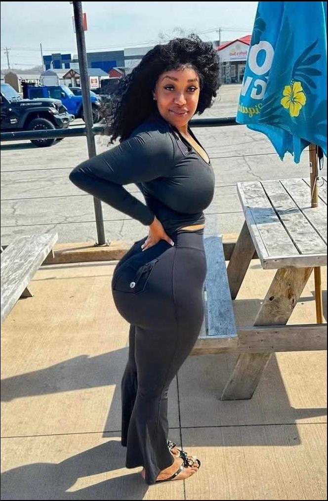 a woman in a black dress holding a white surfboard