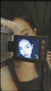 a person holding a camera and a tv