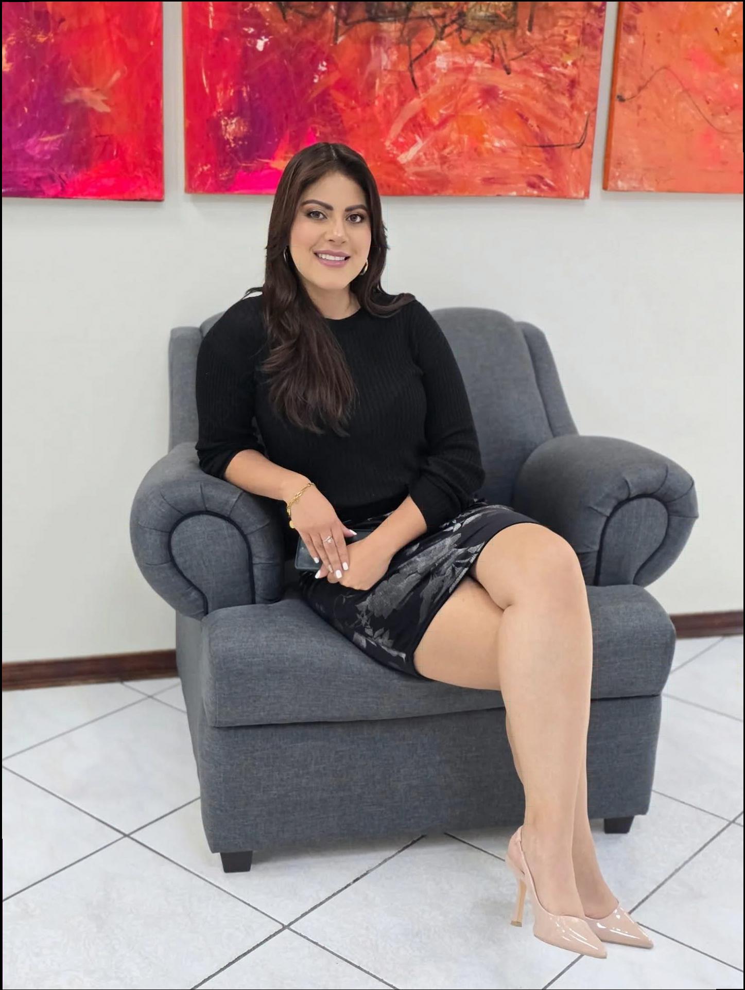 a woman sitting on a couch with a book