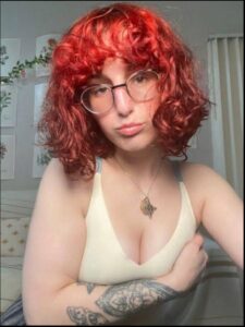 a woman with a red hair and a blue shirt