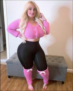 a woman in a pink dress and a pink skirt