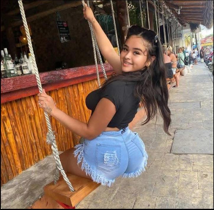 a woman is standing on a wooden bench