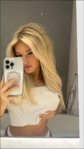 a woman taking a picture of herself in a mirror