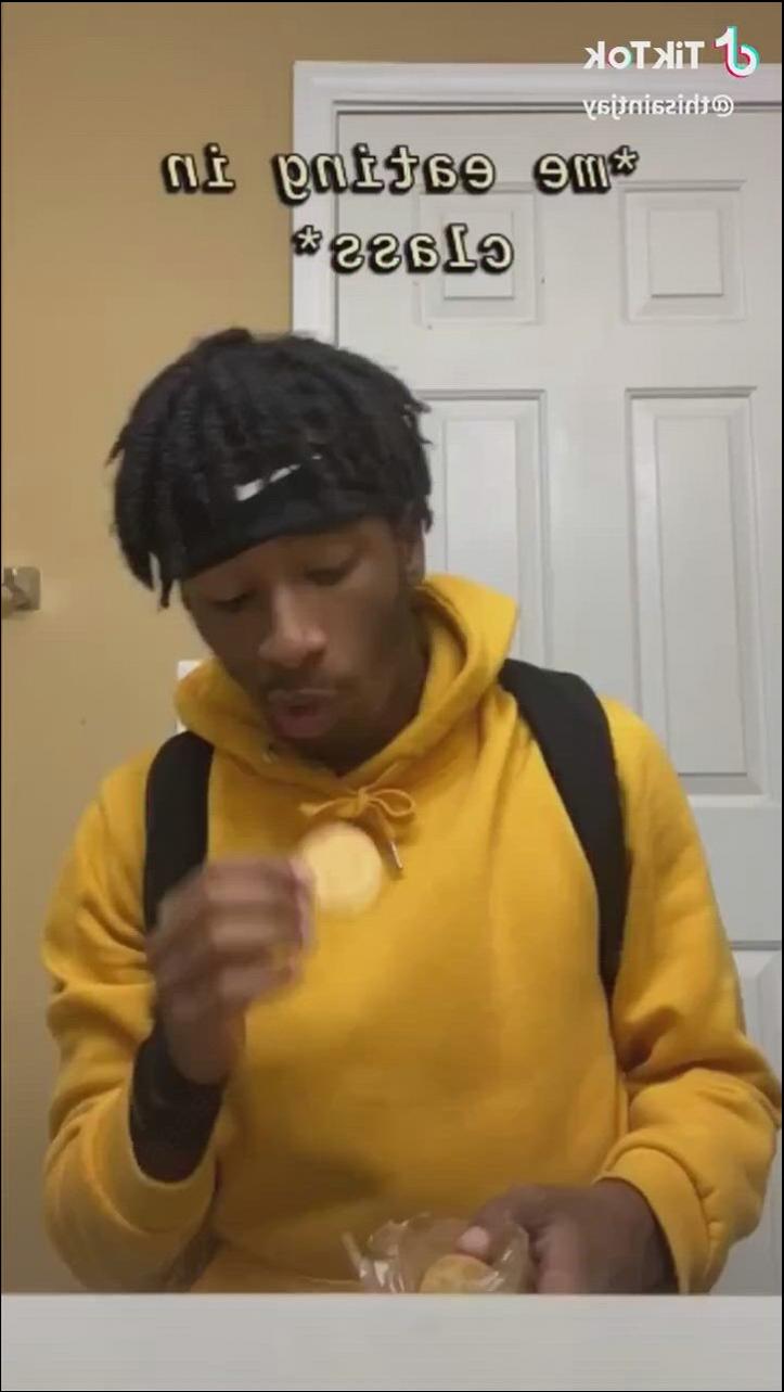 a man eating a banana on a white plate