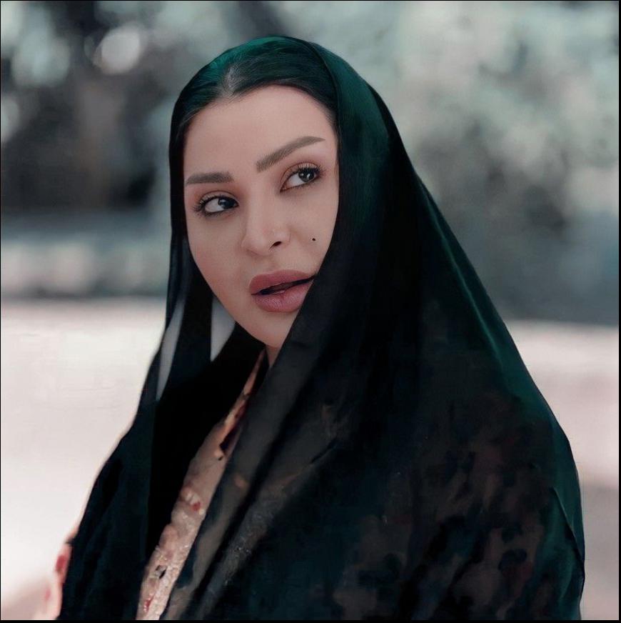 a woman in a black dress is posing for a picture