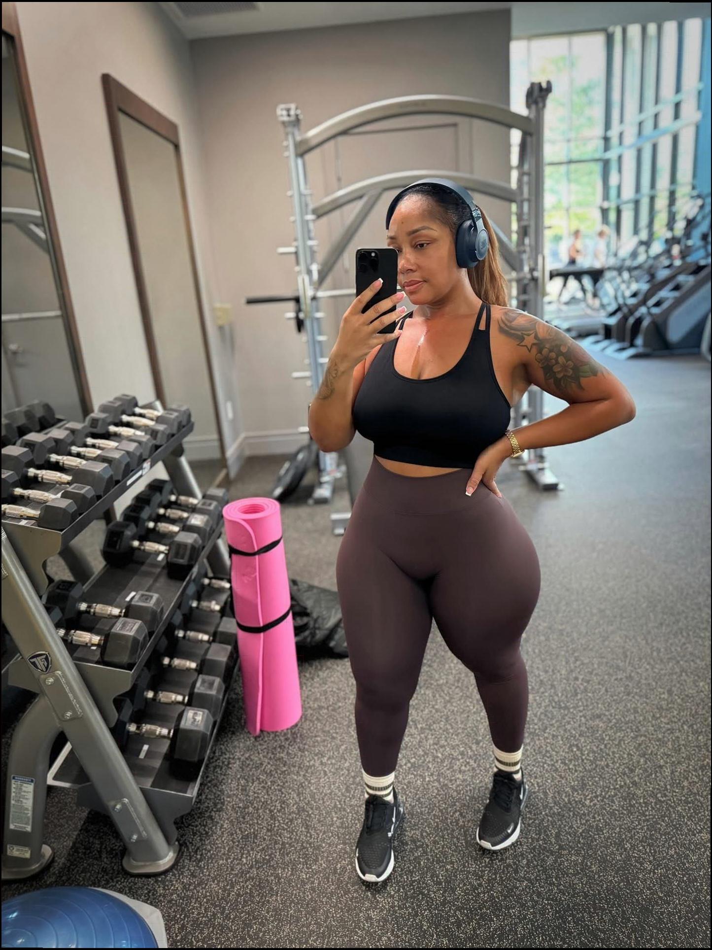 a woman is standing in a parking lot with a cell phone