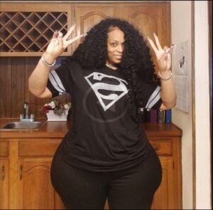 a woman in a black dress is posing for a picture