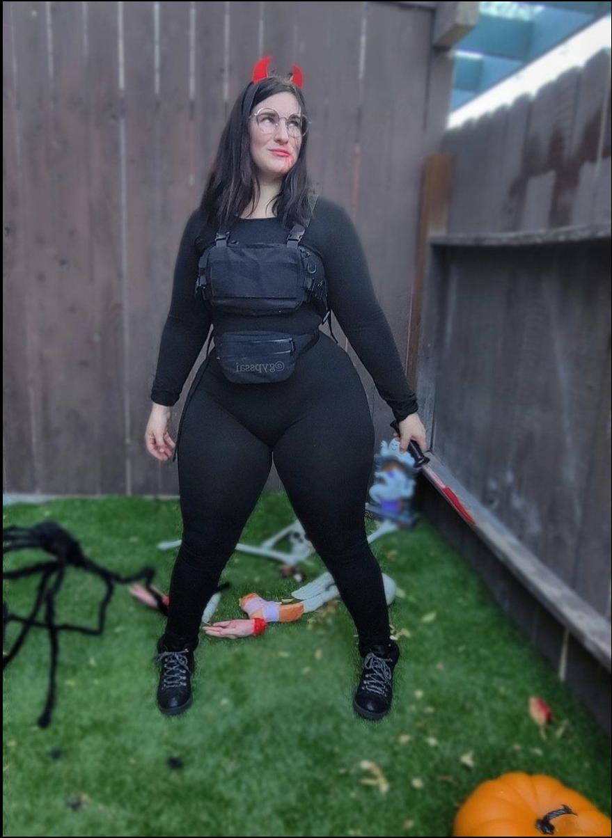 a woman in a black dress is standing on a patio